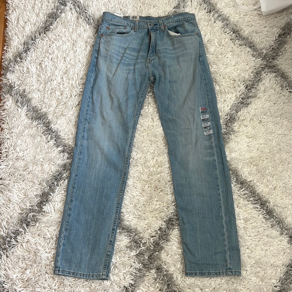 Levi jeans, 505 regular stretch, sits at waist, extra room in thigh, straight.